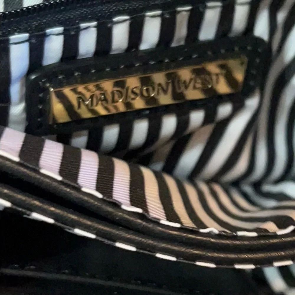 Madison West black wristlet 5 inches high by 7 inches wide with shoulder strap